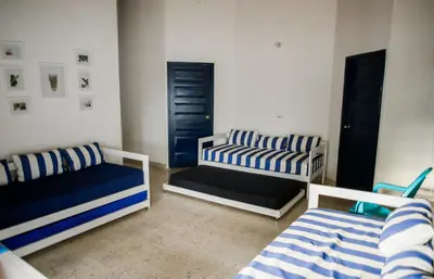 a living room with two beds and a couch at Cabaña Perla Azul in Coveñas