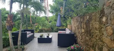 a patio with two couches and a stone wall at Nuestra Casa in Tubará