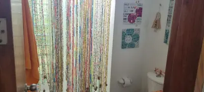 a bathroom with a colorful shower curtain on a wall at Nuestra Casa in Tubará
