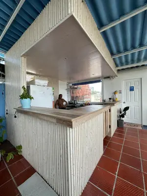 a large kitchen with a counter in a room at Casa Cielo Cartagena in Cartagena de Indias