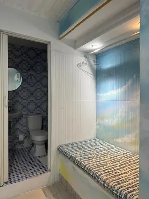 a small bathroom with a toilet and a shower at Casa Cielo Cartagena in Cartagena de Indias