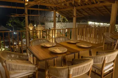 a wooden table and chairs on a patio at Hotel Aimarawa in Coveñas