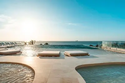 a swimming pool with a view of the ocean at Hilton Santa Marta in Santa Marta