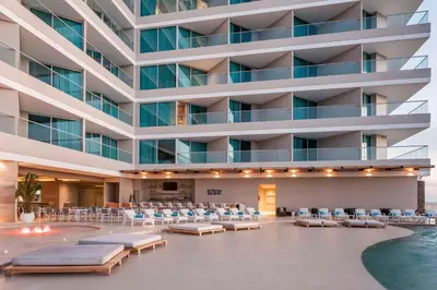 a hotel lobby with chairs and a pool at Hilton Santa Marta in Santa Marta