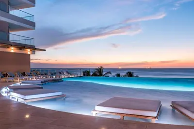 a resort with a pool with a view of the ocean at Hilton Santa Marta in Santa Marta
