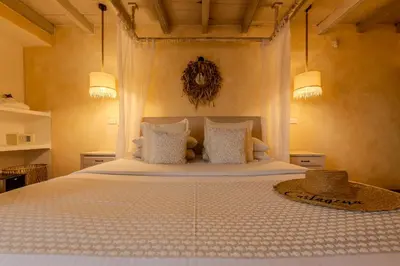 a bedroom with a large bed with white sheets and pillows at Moet Cartagena Hotel Boutique Adutls Only in Cartagena de Indias