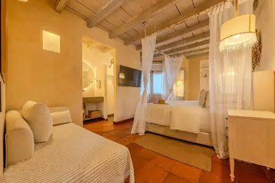 a bedroom with two beds and a television in it at Moet Cartagena Hotel Boutique Adutls Only in Cartagena de Indias
