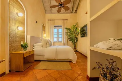 a bedroom with a bed and a ceiling fan at Moet Cartagena Hotel Boutique Adutls Only in Cartagena de Indias
