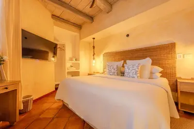 a bedroom with a large white bed and a television at Moet Cartagena Hotel Boutique Adutls Only in Cartagena de Indias