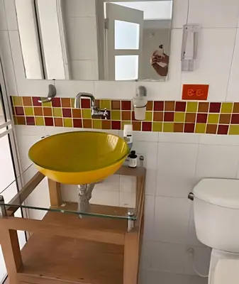 a bathroom with a yellow sink and a toilet at 306Hermoso, céntrico y acogedor loft en Cartagena in Cartagena de Indias
