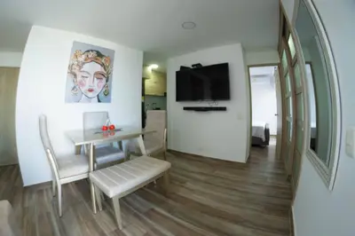 a living room with a table and a dining room at Exclusive House Cartagena in Cartagena de Indias