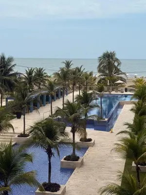 a view of a resort with palm trees and a pool at Vista al mar Morros Ultra in Cartagena de Indias