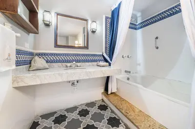 a bathroom with a sink and a tub and a mirror at Amazing Colonial Mansion Old City Cartagena in Cartagena de Indias