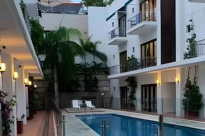 a hotel swimming pool in the middle of a building at 212 Cartagena Walled City Magical Apt in Cartagena de Indias