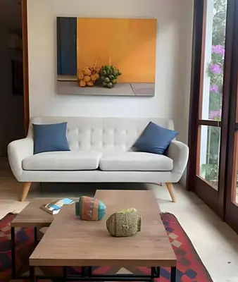 a living room with a white couch and blue pillows at 212 Cartagena Walled City Magical Apt in Cartagena de Indias