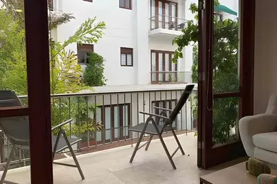 a room with a balcony with a chair at 212 Cartagena Walled City Magical Apt in Cartagena de Indias
