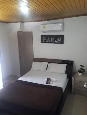 a bed in a room with a sign on the wall at buenavista class in Barranquilla