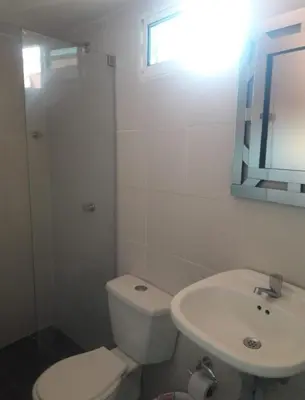 a white bathroom with a toilet and a sink at buenavista class in Barranquilla
