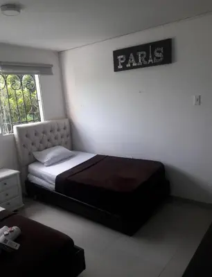 a bedroom with a bed and a sign on the wall at buenavista class in Barranquilla