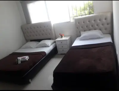 a bedroom with two beds and a window at buenavista class in Barranquilla