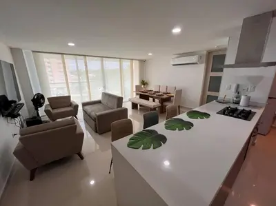 a kitchen and living room with a table and chairs at Excelente Apartamento en Villa Campestre, Barranquilla in Puerto Colombia