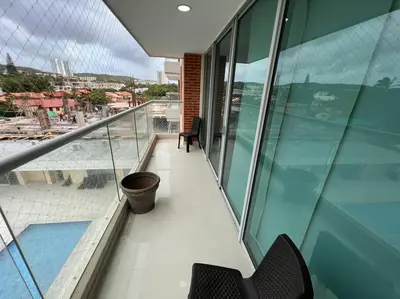 a balcony of a building with two chairs and a pool at Excelente Apartamento en Villa Campestre, Barranquilla in Puerto Colombia