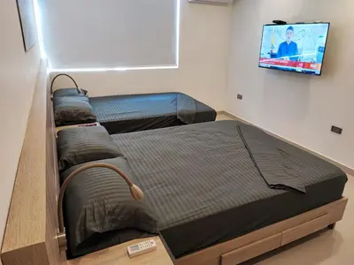 two beds in a room with a tv on the wall at APARTAMENTO MODERNO EL LAGUITO JUNTO AL MAR 705 in Cartagena de Indias