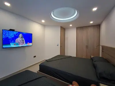 a bedroom with a bed and a flat screen tv on the wall at APARTAMENTO MODERNO EL LAGUITO JUNTO AL MAR 705 in Cartagena de Indias