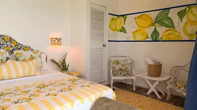 a bedroom with a bed and a painting on the wall at Mio Mio Beach in Baru