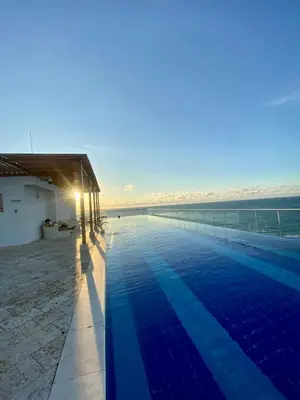 a swimming pool with the ocean in the background at Ocean Drive Beach House - Cartagena in Cartagena de Indias