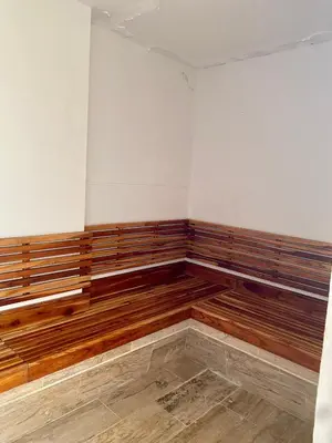 a empty room with wooden benches in the corner at Ocean Drive Beach House - Cartagena in Cartagena de Indias