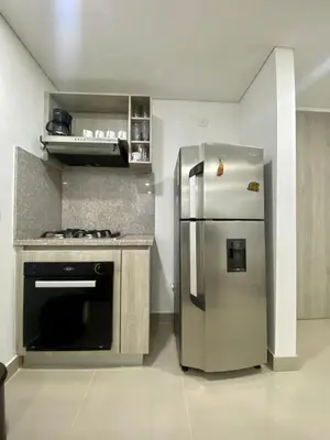 a kitchen with a stainless steel refrigerator and a stove at Ocean Drive Beach House - Cartagena in Cartagena de Indias