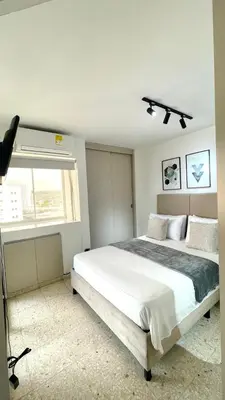 a bedroom with a large bed and a window at Cabrero Beach 1212 in Cartagena de Indias