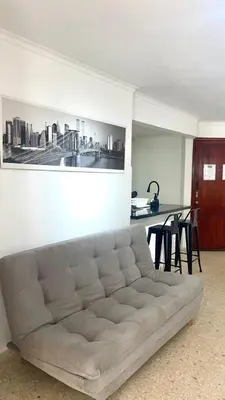 a white couch in a living room with a table at Cabrero Beach 1212 in Cartagena de Indias