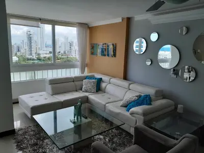 a living room with a couch and a glass table at Oceanside 3-bedroom apartment in fun tourist area in Cartagena de Indias