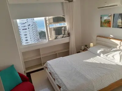 a bedroom with a bed and a large window at Oceanside 3-bedroom apartment in fun tourist area in Cartagena de Indias
