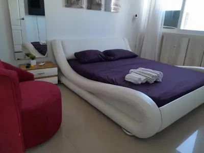 a bed with a white frame in a room at Oceanside 3-bedroom apartment in fun tourist area in Cartagena de Indias