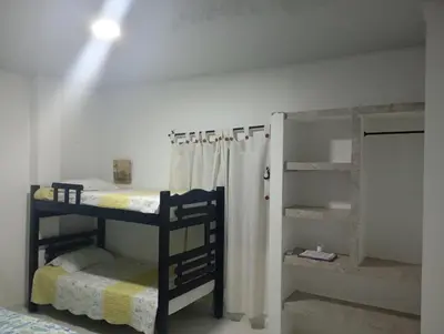 a room with two bunk beds and a closet at Cabaña Rochy in Coveñas