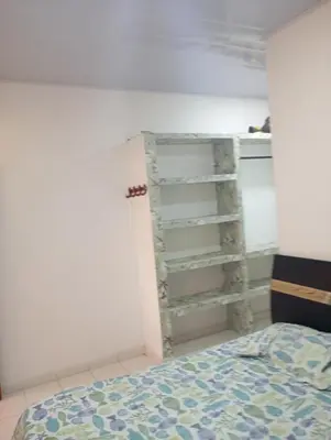 a bedroom with a bed and a book shelf at Cabaña Rochy in Coveñas