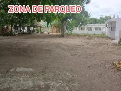 a parking lot with a tree and a sign that reads zona de pancho at Cabaña Rochy in Coveñas