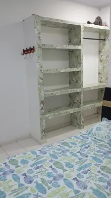 a bedroom with a book shelf and a bed at Cabaña Rochy in Coveñas