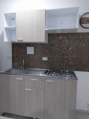 a kitchen with a sink and a stove at Cabañas Berakah in Coveñitas