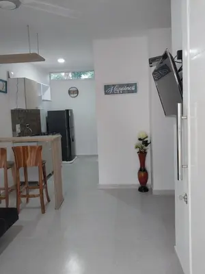 a kitchen with a table and chairs and a refrigerator at Cabañas Berakah in Coveñitas