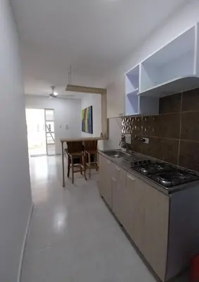 a kitchen with a stove and a table in it at Cabañas Berakah in Coveñitas