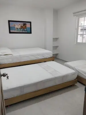a bedroom with two bunk beds and a window at Cabañas Berakah in Coveñitas