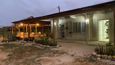 a house with a porch with lights on it at Cabañas Paulamar - Apto 2 - Tolu in La Gloria