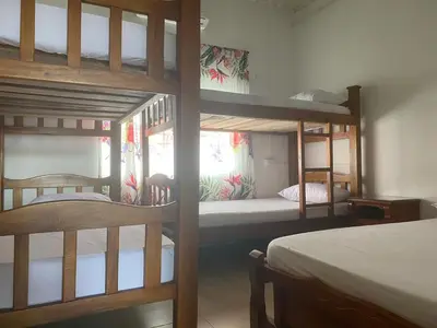 a room with two bunk beds and a bed at Cabañas Paulamar - Apto 2 - Tolu in La Gloria