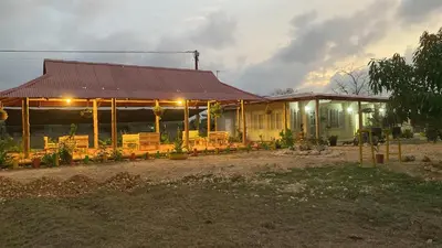 a building with tables and chairs in front of it at Cabañas Paulamar - Apto 2 - Tolu in La Gloria
