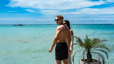 a man and a woman standing on the beach at Cristal Blue Barú in Baru