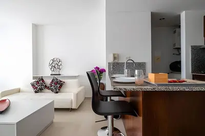 a kitchen and living room with a table and a couch at Apartamento 1 Dormitorio Morros. Vista Mar Piscina in Cartagena de Indias